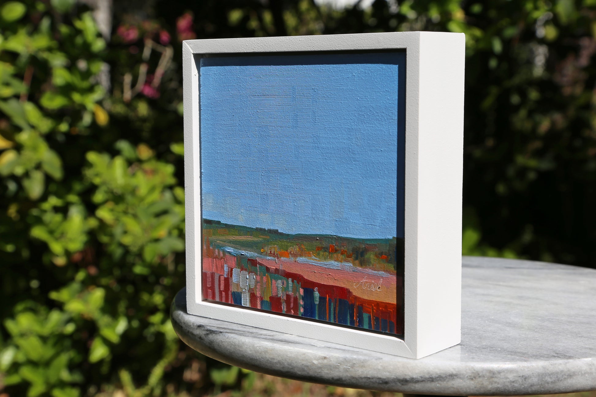 Experience the beauty of nature with Maribel, an original oil painting. Its abstract landscape features vibrant and bold brush strokes in shades of pinks, blues, and greens. A little piece that will add elegance to any space.