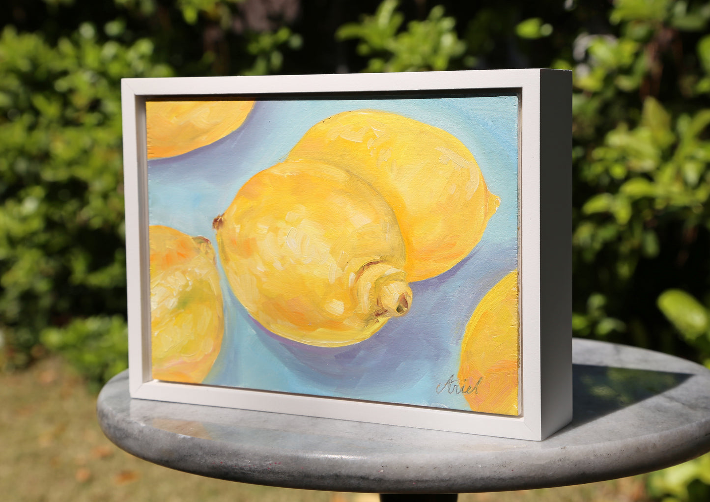 This Lemons #2 fine art oil painting captures the essence of a vibrant still life, perfect for adding a touch of elegance to any home decor. With a sleek white frame, this ready to hang piece is a must-have for any art lover. Bring a burst of color and sophistication into your space.