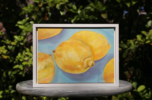 This Lemons #2 fine art oil painting captures the essence of a vibrant still life, perfect for adding a touch of elegance to any home decor. With a sleek white frame, this ready to hang piece is a must-have for any art lover. Bring a burst of color and sophistication into your space.
