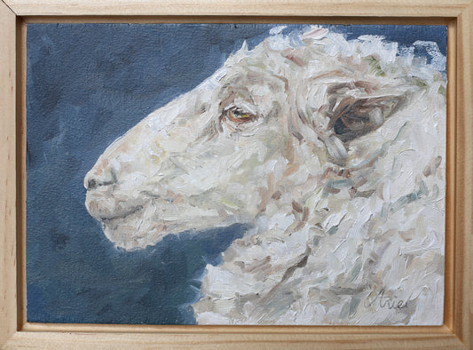 Painting of a sheep's head on a blue background with a wooden frame.