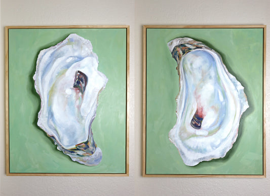 two oysters with soft green backgrounds.